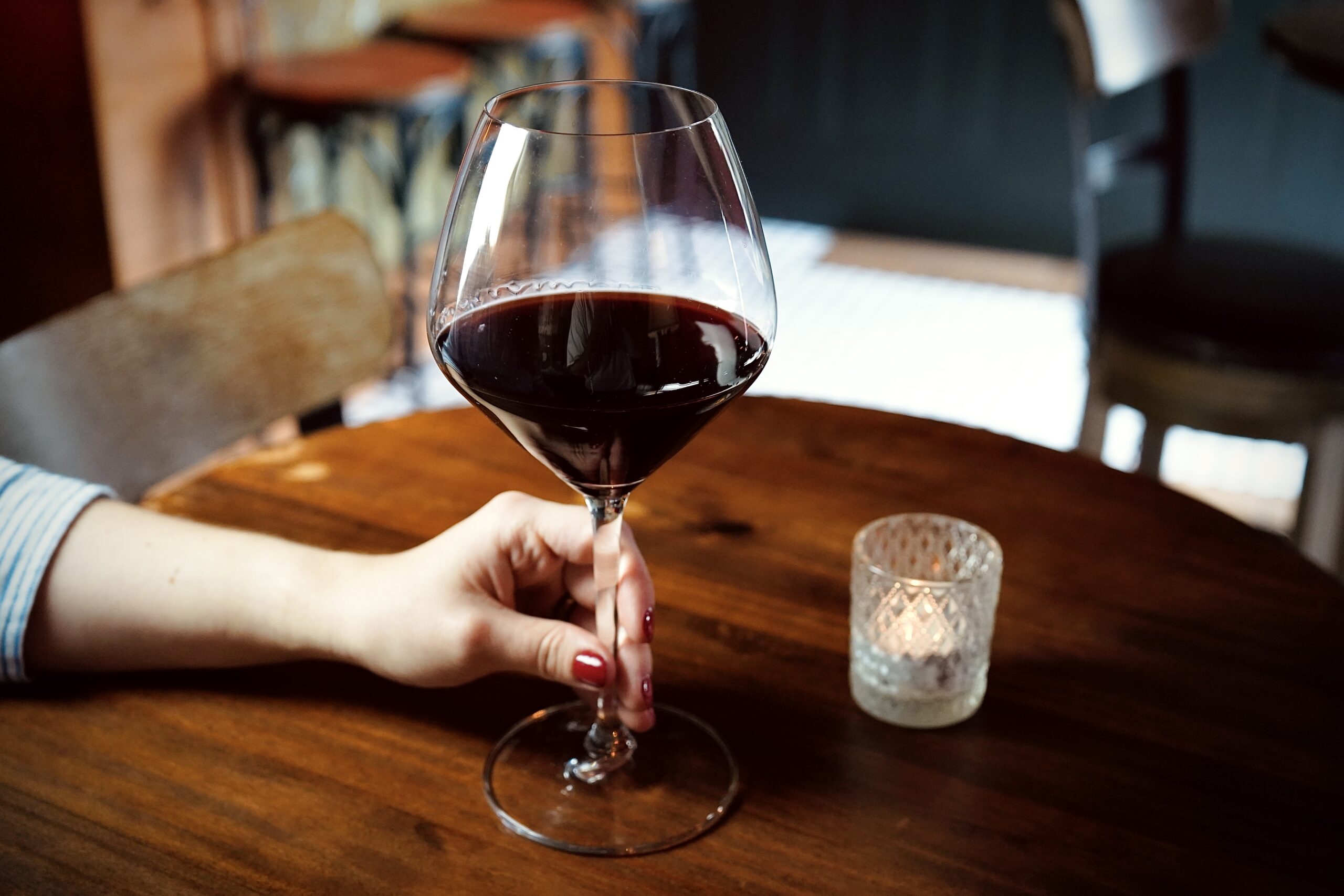 Sommelier pouring Italian red wine at The Authentique Nashville